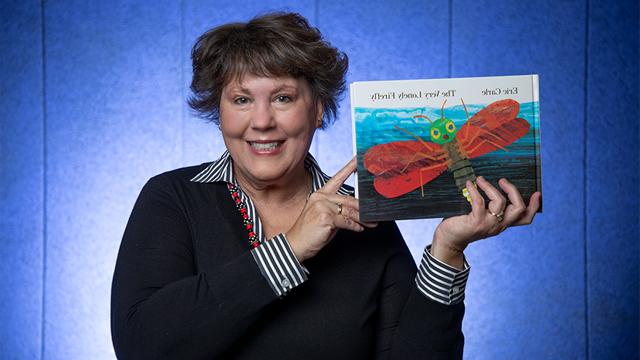 Kim Ratliff holding up the book The Very Lonely Firefly by Eric Carle